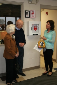 Nancy Alderdyce installing the AED with Jean and George Ross at Starry Elementary